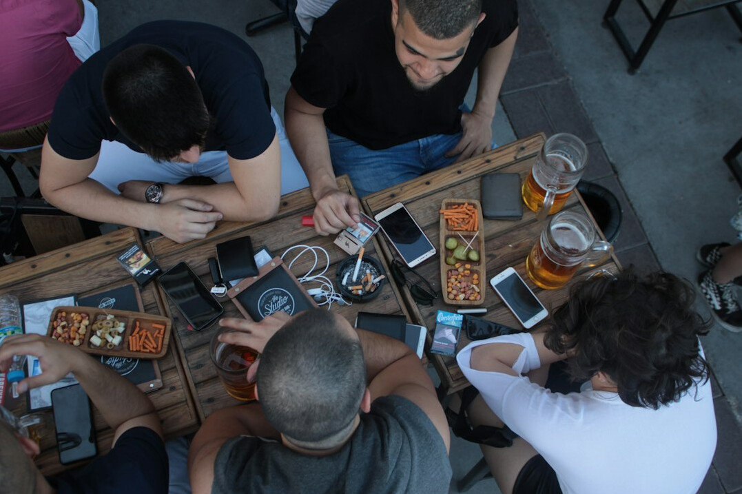 group of friends chatting on smartphones