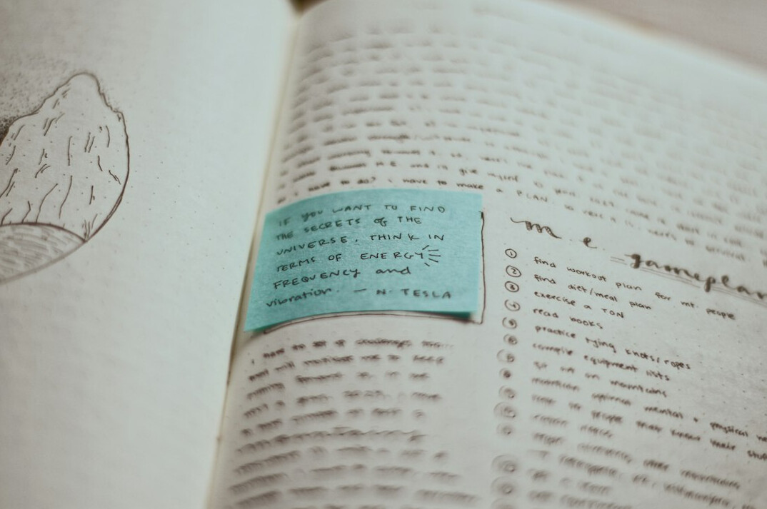 Close-up of handwritten research notes and a fountain pen on a wooden desk